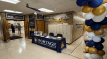 School hallway with decorated table, balloons, and lockers.