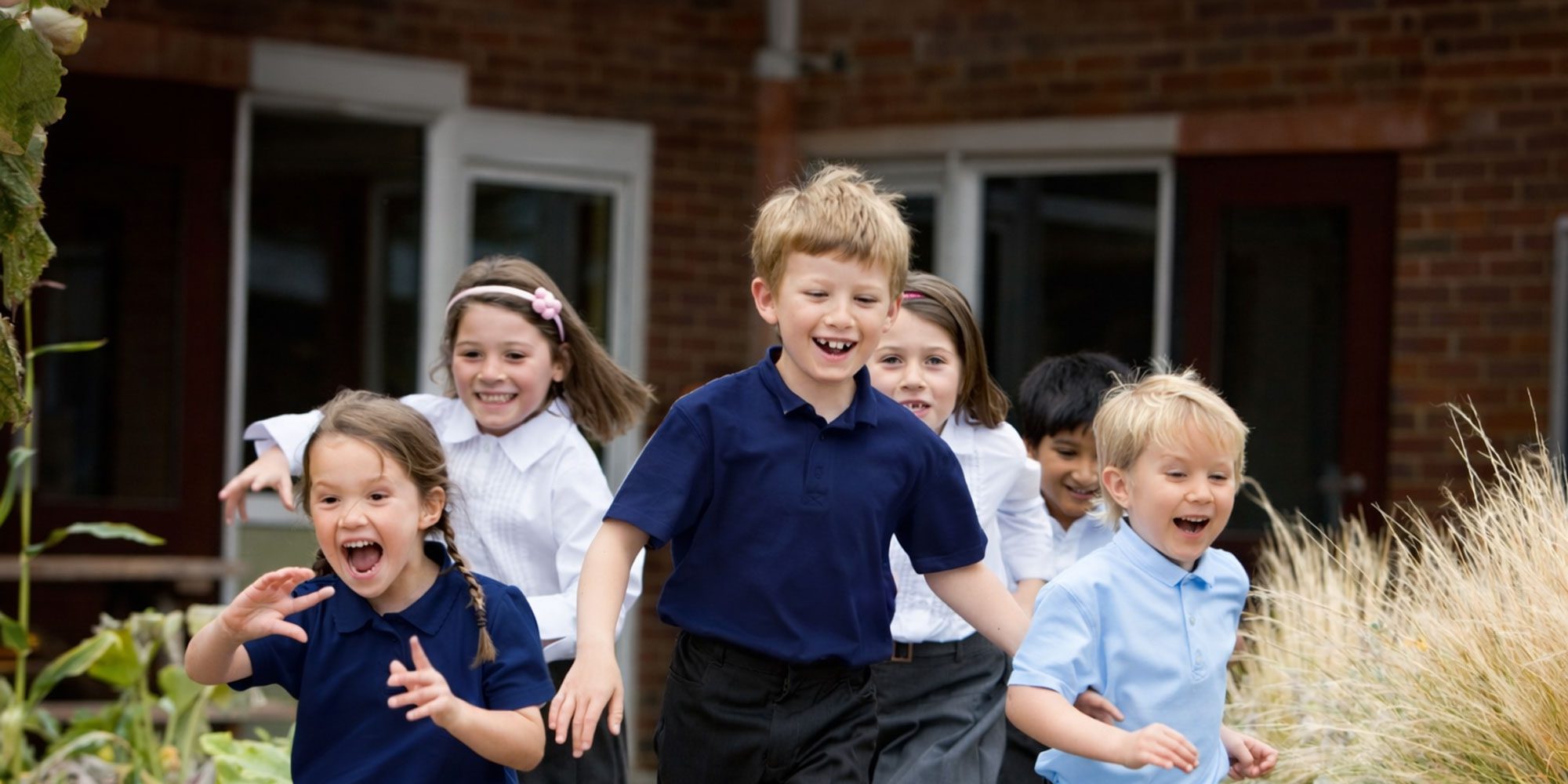 Kids running outside of school building